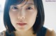 A close up of a woman with short black hair.
