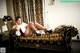 A woman sitting on a couch with her legs crossed.