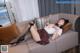 A woman laying on a couch with her legs crossed.